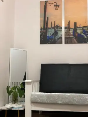 a living room with a couch and a picture on the wall at Simple Living in Anabu Primero