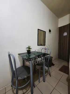 a table and chairs in a room with a mirror at Macks Awesome 12 Place Fast Wifi Netflix in Manila