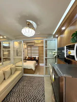 a bedroom with a bed and a desk in a room at Katkat Shore 2 Staycation in Manila