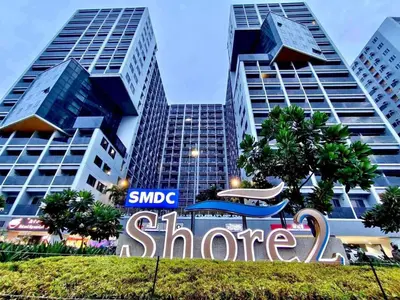 a store sign in front of tall buildings at Shore 2 Residences MOA DMBV in Manila