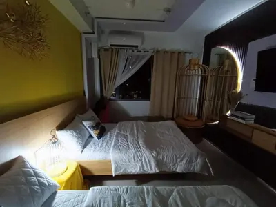 a bedroom with a white bed with a window at Shore 2 Residences MOA DMBV in Manila