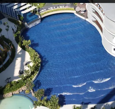 an overhead view of a large pool of water at 2BR Cozy Condo at Azure Urban Resort Residences by Gigi in Manila