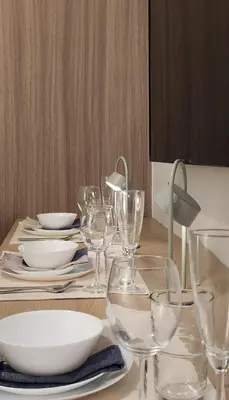 a table with wine glasses and plates on it at The New Villa at Shore 2 Residences in Manila