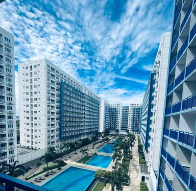 a view of a city with a pool and buildings at MOA Sea Residence - Oasis MNL in Manila