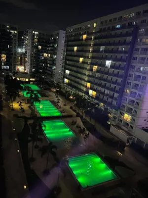 a group of green lights in a city at night at MOA Sea Residence - Oasis MNL in Manila