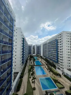 an aerial view of a city with two swimming pools at MOA Sea Residence - Oasis MNL in Manila
