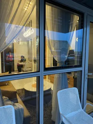 a room with a window with two chairs and a table at Stylish 1BR Near Airport Facing the Bay - 9d in Manila