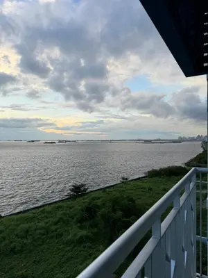 a view of a large body of water from a balcony at Panoramic Seaview 2BR Near Airport Facing the Bay - 7g in Manila