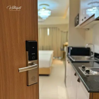 a door in a room with a kitchen with a counter at Homefort at Lush Residences Makati in Manila