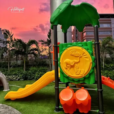 a playground with a slide in a park at Homefort at Lush Residences Makati in Manila