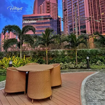 a patio with a table and chairs in a city at Homefort at Lush Residences Makati in Manila