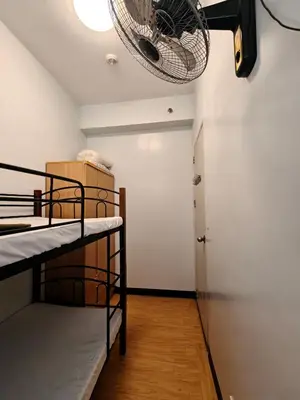 a room with two bunk beds and a fan at Fully-furnished 2BR Condo in Pasig, Cainta in Cainta