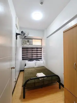 a small bedroom with a bed in a room at Fully-furnished 2BR Condo in Pasig, Cainta in Cainta
