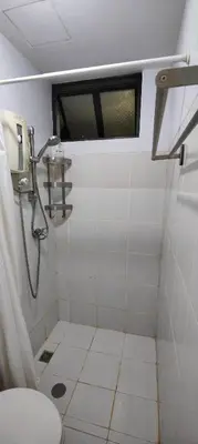 a small bathroom with a toilet and a window at Fully-furnished 2BR Condo in Pasig, Cainta in Cainta