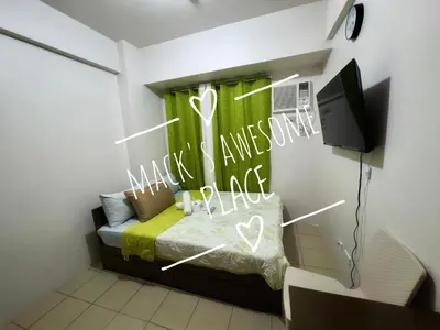 a bedroom with a bed with a sign that says make sure you have a heart at Macks Awesome 07 Fast Wifi Premium Netflix in Manila