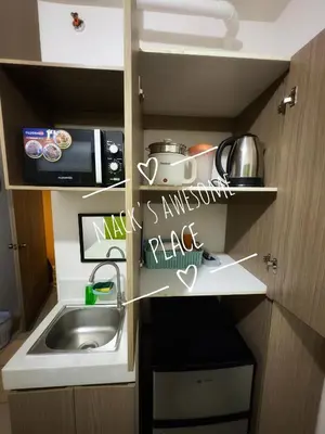 a small kitchen with a sink and a microwave at Macks Awesome 07 Fast Wifi Premium Netflix in Manila