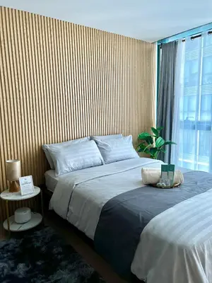 a bedroom with two beds and a large window at Affordable One Bedroom at One Uptown, BGC Manila in Manila
