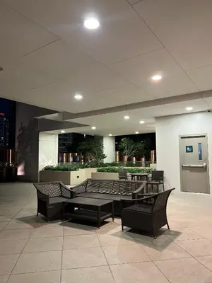 a lobby with tables and chairs in a building at Affordable One Bedroom at One Uptown, BGC Manila in Manila