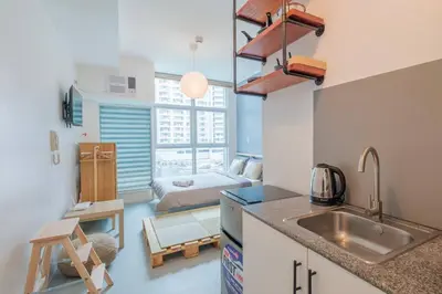 a kitchen with a sink and a room with a bed at Japanese Stylish Condo in Makati in Manila