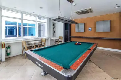 a living room with a pool table in it at Japanese Stylish Condo in Makati in Manila