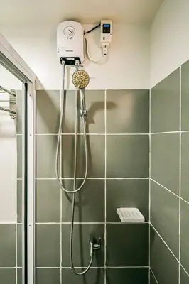 a shower with a shower head in a bathroom at Paradise Room in Las Piñas City in Manila