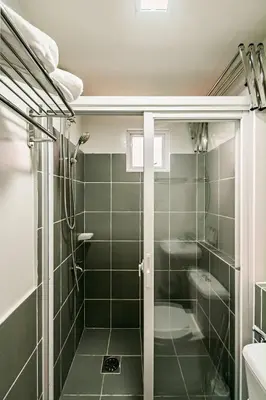 a bathroom with a shower and a toilet at Paradise Room in Las Piñas City in Manila