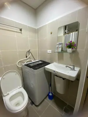 a small bathroom with a toilet and a sink at Coast Residences by Casa Stellar in Manila