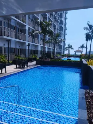 a swimming pool at a hotel with a resort at Coast Residences by Casa Stellar in Manila