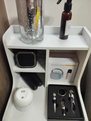 a white shelf with a vase and other items on it at Coast Residences by Casa Stellar in Manila