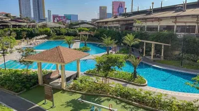 an overhead view of a large swimming pool in a city at Prisma Residences Astra Building in Manila