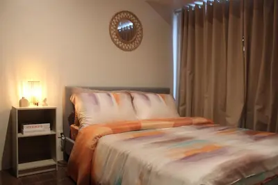 a bedroom with a bed and a mirror on the wall at Air Residence 1BR Condo with City View in Manila