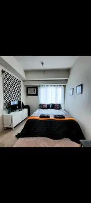 a bedroom with a large bed and a window at THE BEACON Aparthotels in Manila