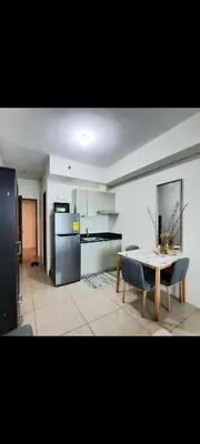 a kitchen with a table and a refrigerator at THE BEACON Aparthotels in Manila