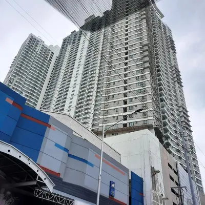 a large tall building with a building under construction at THE BEACON Aparthotels in Manila