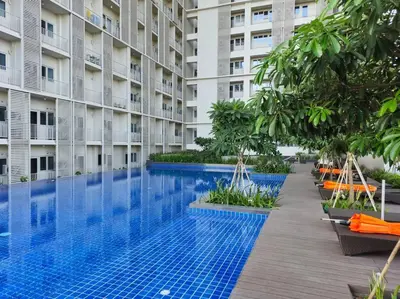 an empty swimming pool in front of a building at Modern & New, Work Desk, Fast Internet, Balcony in Manila