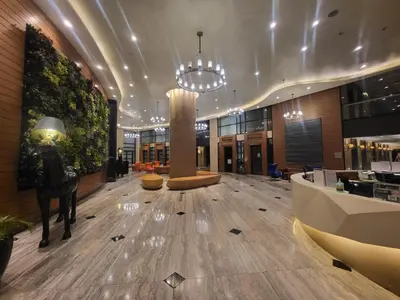 a lobby with a statue of a man on a horse at Scandi Inspired Studio in Knightsbridge, Makati in Manila