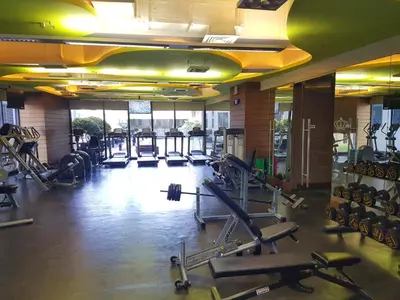a gym with a lot of treadmills and machines at Scandi Inspired Studio in Knightsbridge, Makati in Manila