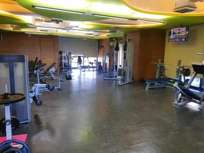 a gym with several treadmills and machines in a room at Scandi Inspired Studio in Knightsbridge, Makati in Manila