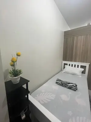 a small bedroom with a bed with a plant on it at Entire unit with balcony at SMDC Field Residences, behind Sucat near NAIA in Manila