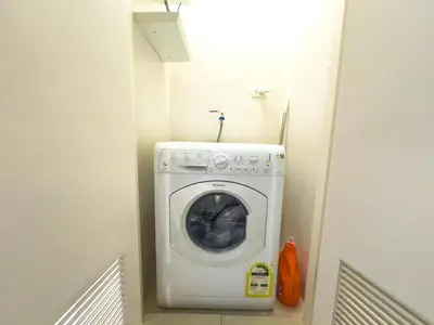 a washer and dryer in a small room at 1BR BGC, One Uptown Residence B001 in Manila