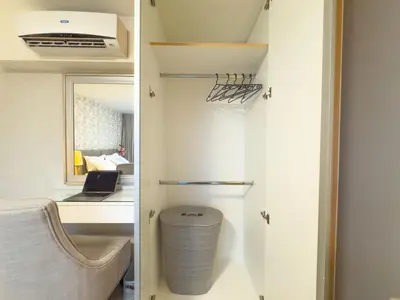 a room with a desk and a chair and a laptop at 1BR BGC, One Uptown Residence B001 in Manila