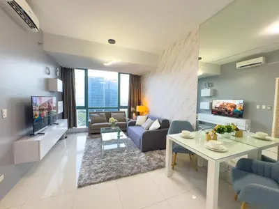 a living room with a couch and a table at 1BR BGC, One Uptown Residence B001 in Manila