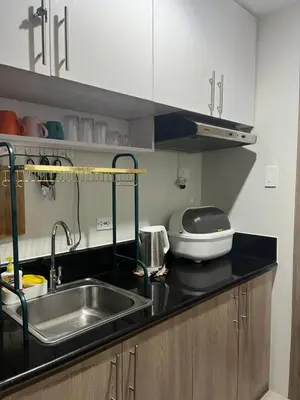 a kitchen with a sink and a counter top at Chill in Peace Staycation 2BR condo at Field Residences, Sucat near NAIA in Manila