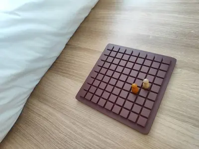 a brown keyboard on a bed with two pieces of food at Oak Apartment at The Rochester Bridgeview Tower in Manila