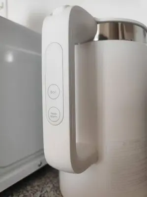 a white appliance sitting next to a microwave at Oak Apartment at The Rochester Bridgeview Tower in Manila