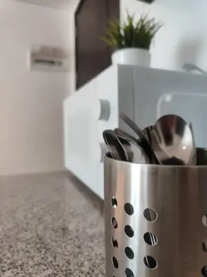 a metal container with utensils in a kitchen at Oak Apartment at The Rochester Bridgeview Tower in Manila