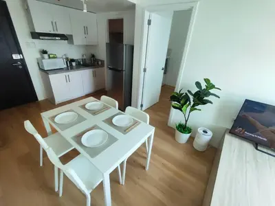 a white table and chairs in a small kitchen at Oak Apartment at The Rochester Bridgeview Tower in Manila