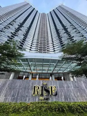 a tall building with a sign in front of it at Comfy Relax Condo at the Rise Makati in Manila