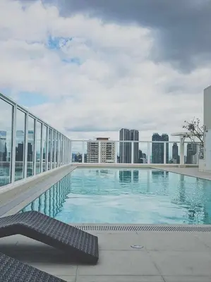 a swimming pool on the roof of a building at Bigg Apol Suite in Manila