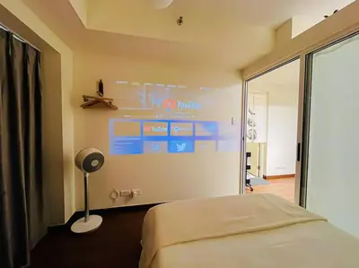 a bedroom with a bed and a sign on the wall at NEW! Studio Condo in Prisma Residences Pasig in Manila